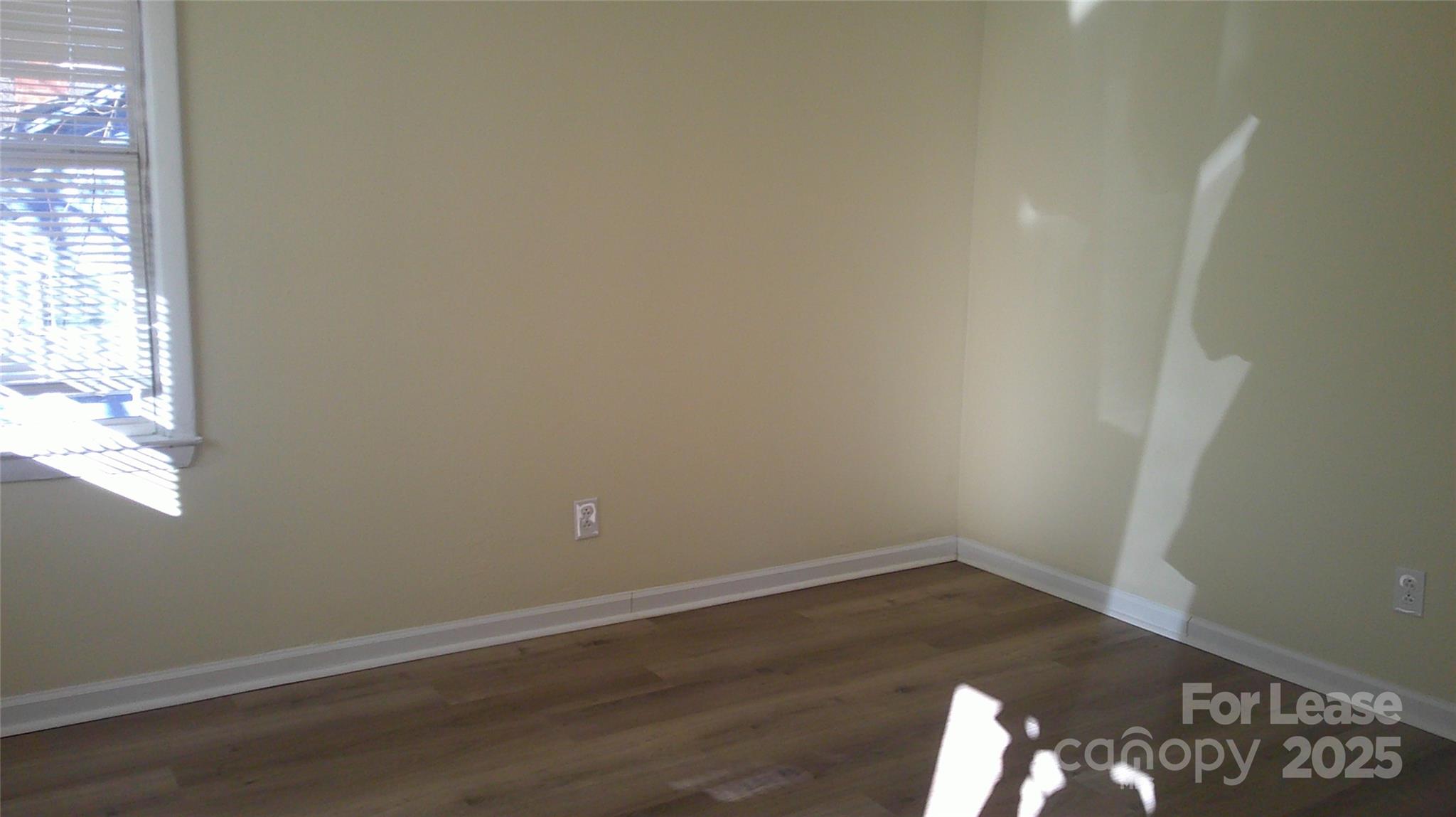607 11th Street Southwest Hickory, NC 28602 - Photo 5 of 5 an empty room with wooden floor and windows