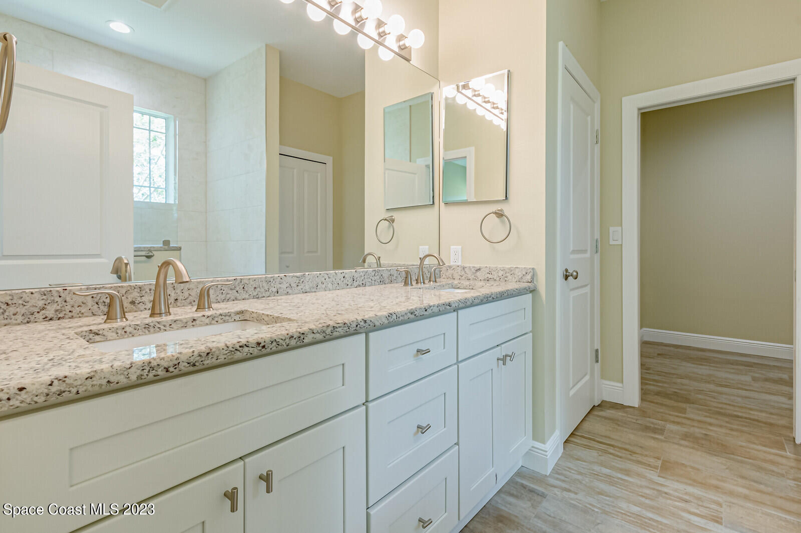 618 Hammock Road Melbourne, FL 32904 - Photo 20 of 59 a bathroom with a granite countertop double vanity sink and mirror