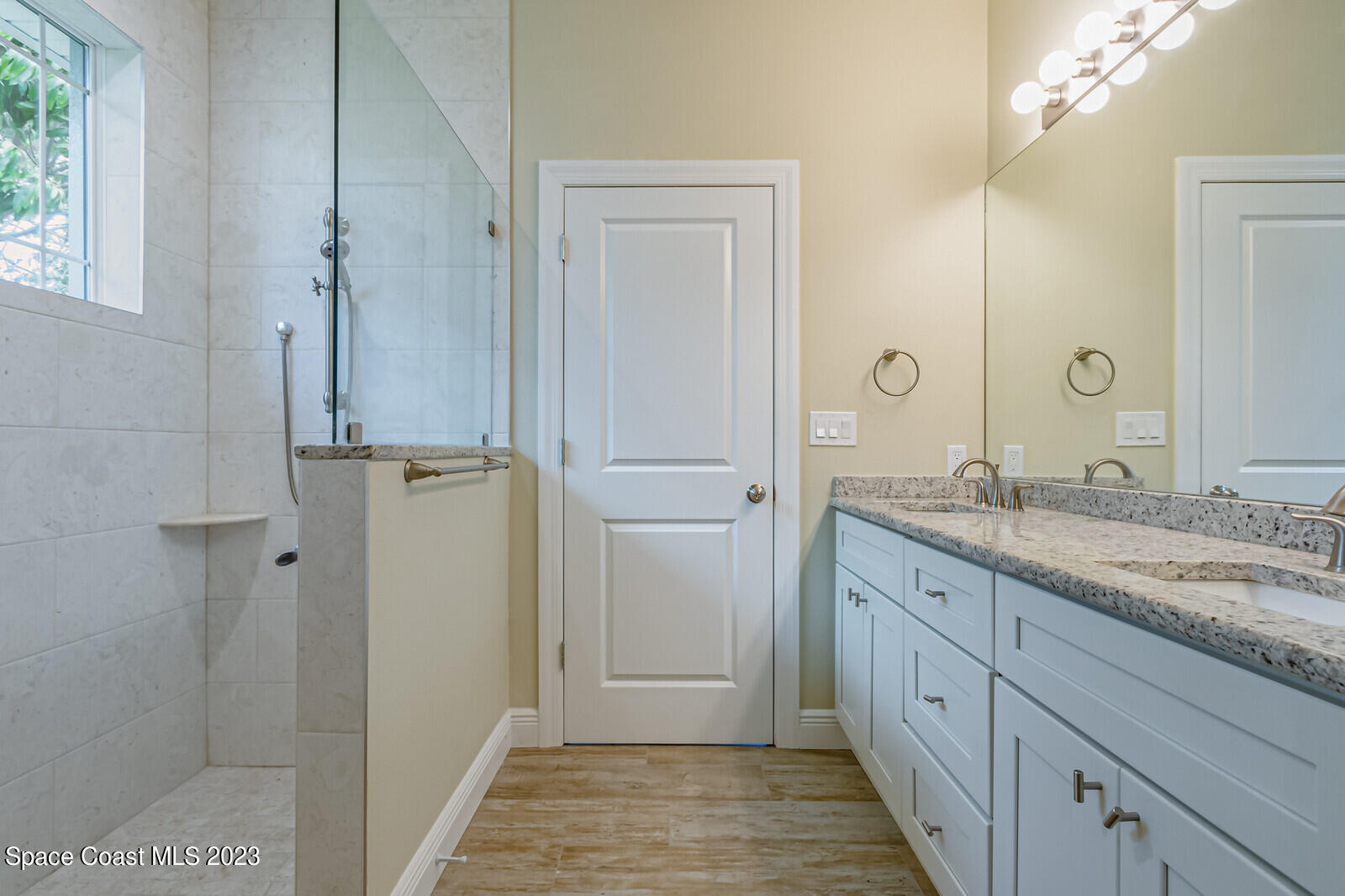 618 Hammock Road Melbourne, FL 32904 - Photo 21 of 59 a bathroom with a granite countertop sink two mirror and shower