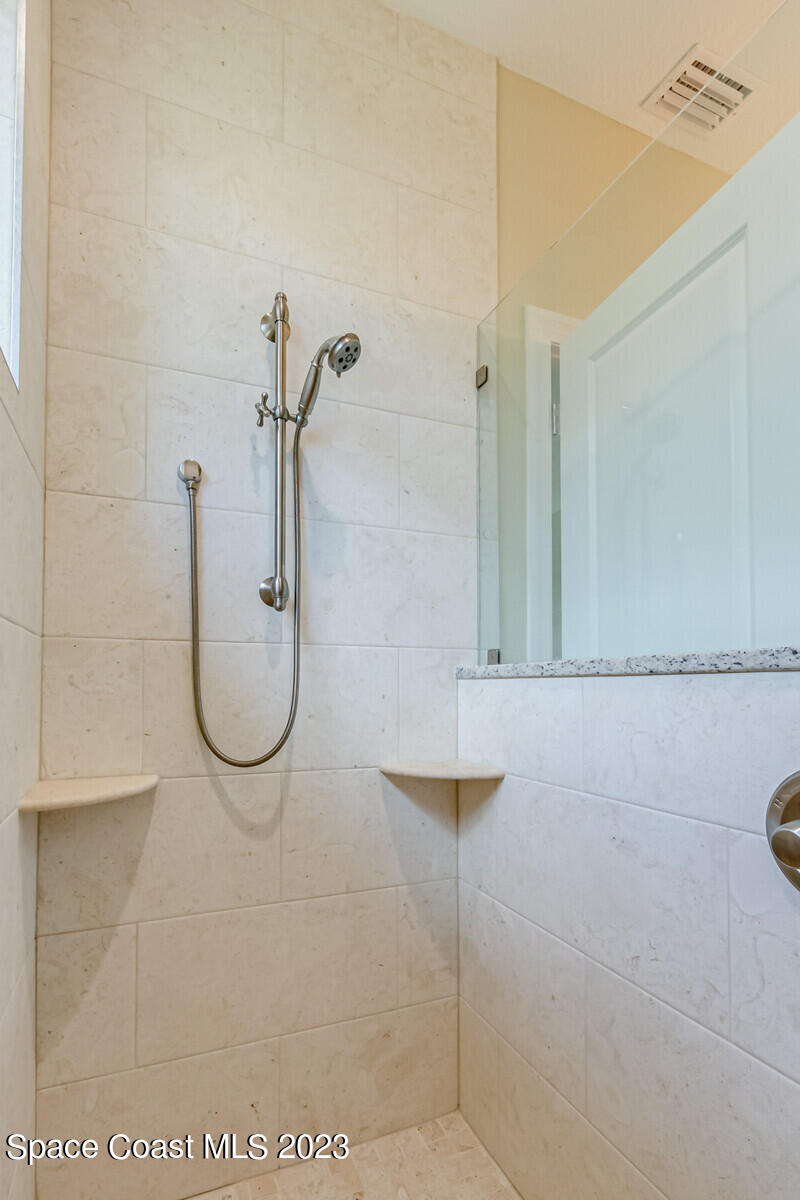 618 Hammock Road Melbourne, FL 32904 - Photo 22 of 59 a bathroom with a shower and mirror