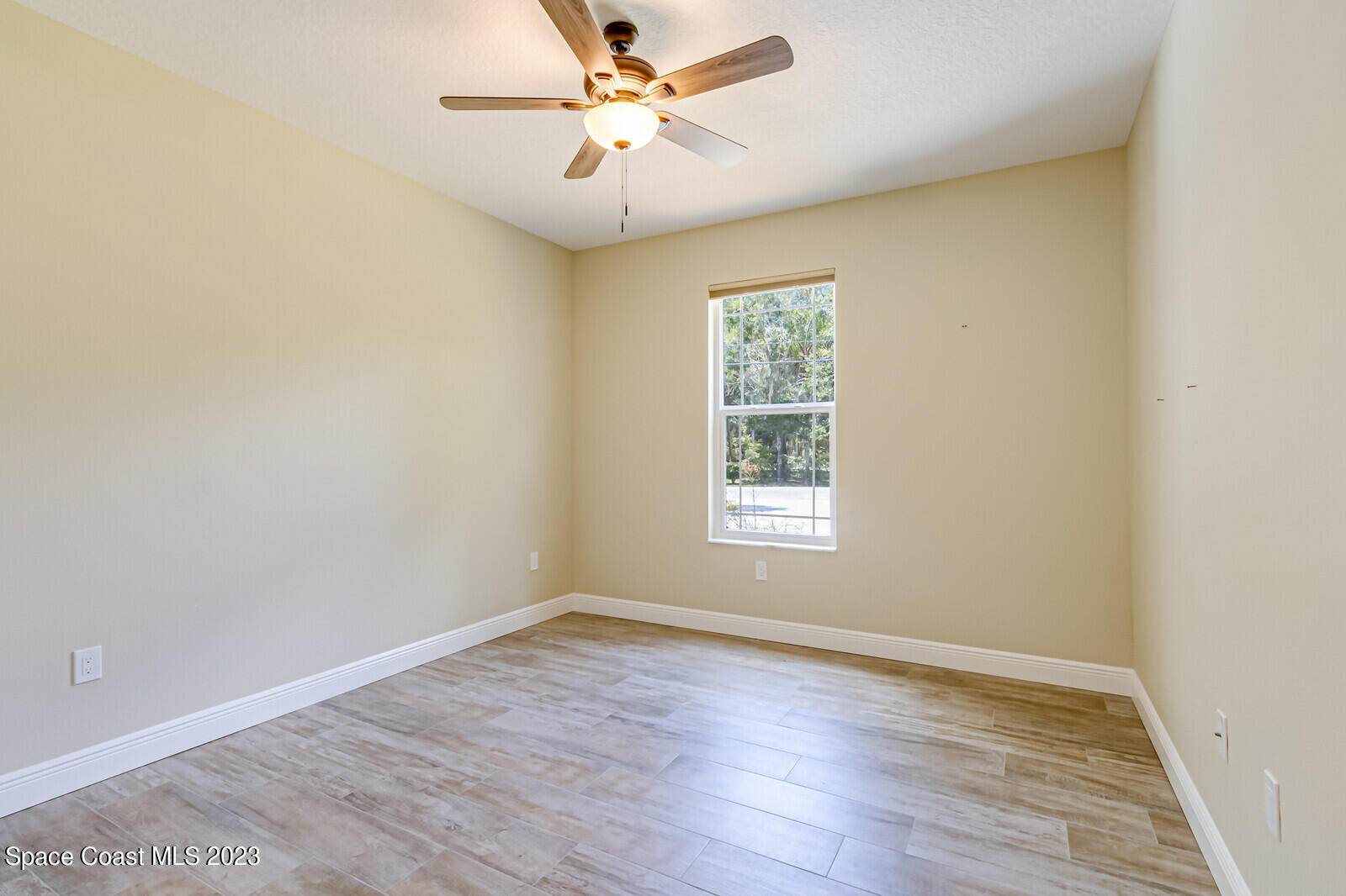 618 Hammock Road Melbourne, FL 32904 - Photo 25 of 59 an empty room with a window and a fan
