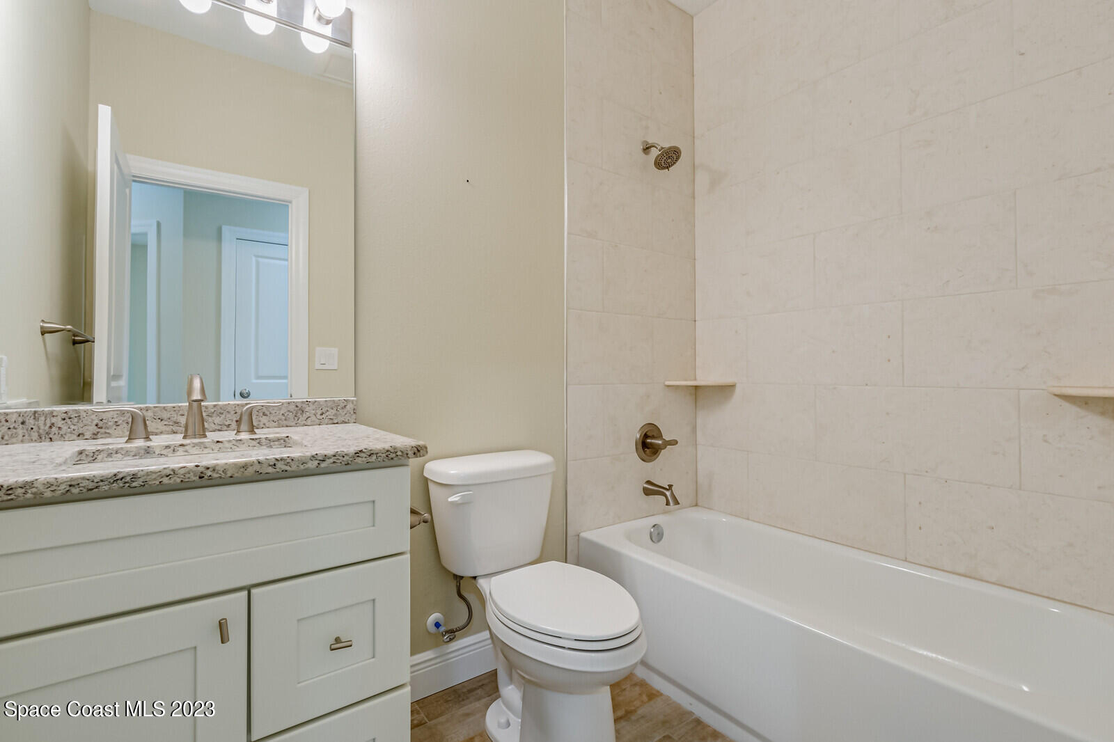 618 Hammock Road Melbourne, FL 32904 - Photo 27 of 59 a bathroom with a granite countertop toilet a sink and a bathtub