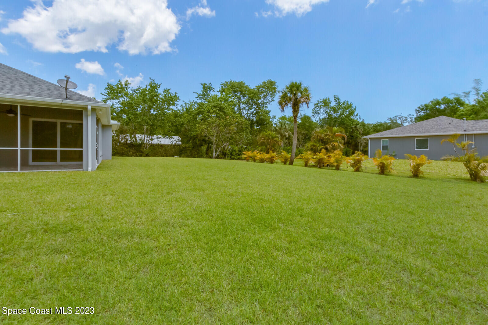 618 Hammock Road Melbourne, FL 32904 - Photo 36 of 59 a view of a house with a big yard and potted plants