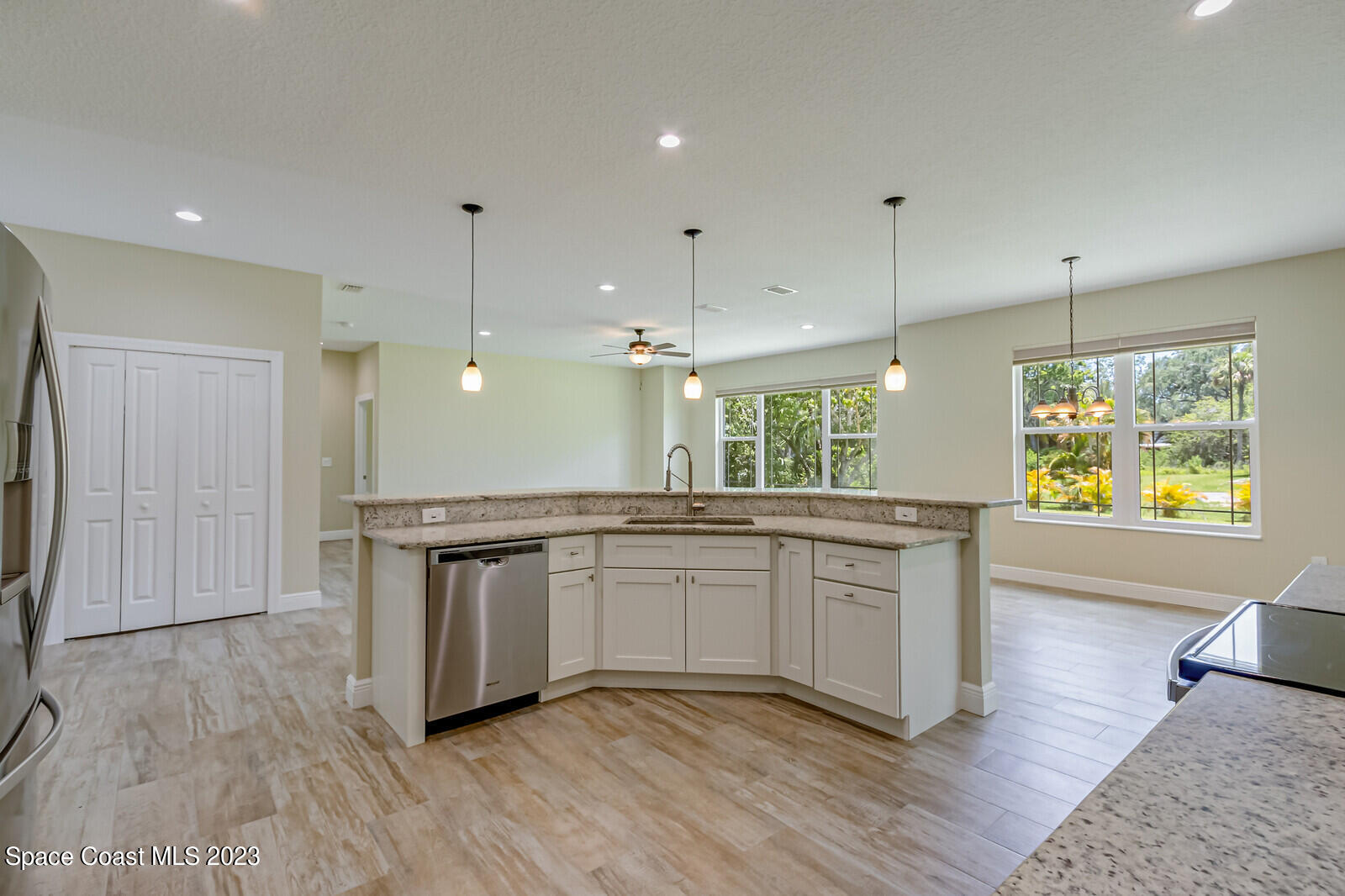 618 Hammock Road Melbourne, FL 32904 - Photo 8 of 59 a kitchen with stainless steel appliances granite countertop a stove a sink and a refrigerator