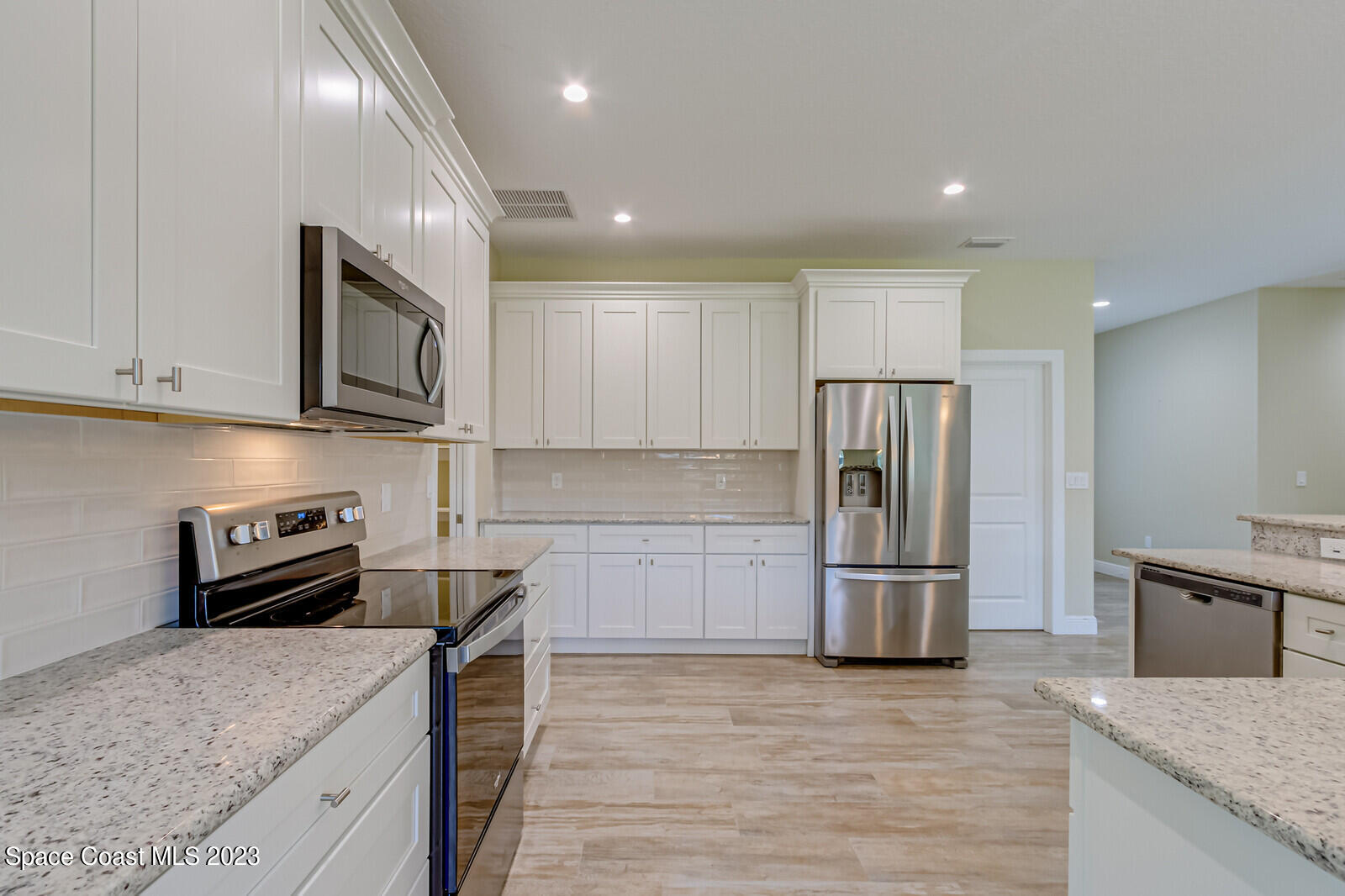618 Hammock Road Melbourne, FL 32904 - Photo 10 of 59 a kitchen with kitchen island granite countertop a stove and a refrigerator