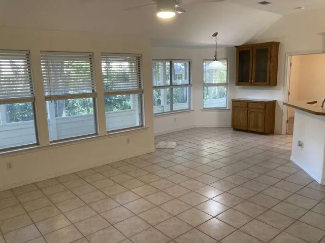 a view of a kitchen with furniture and stainless steel appliances