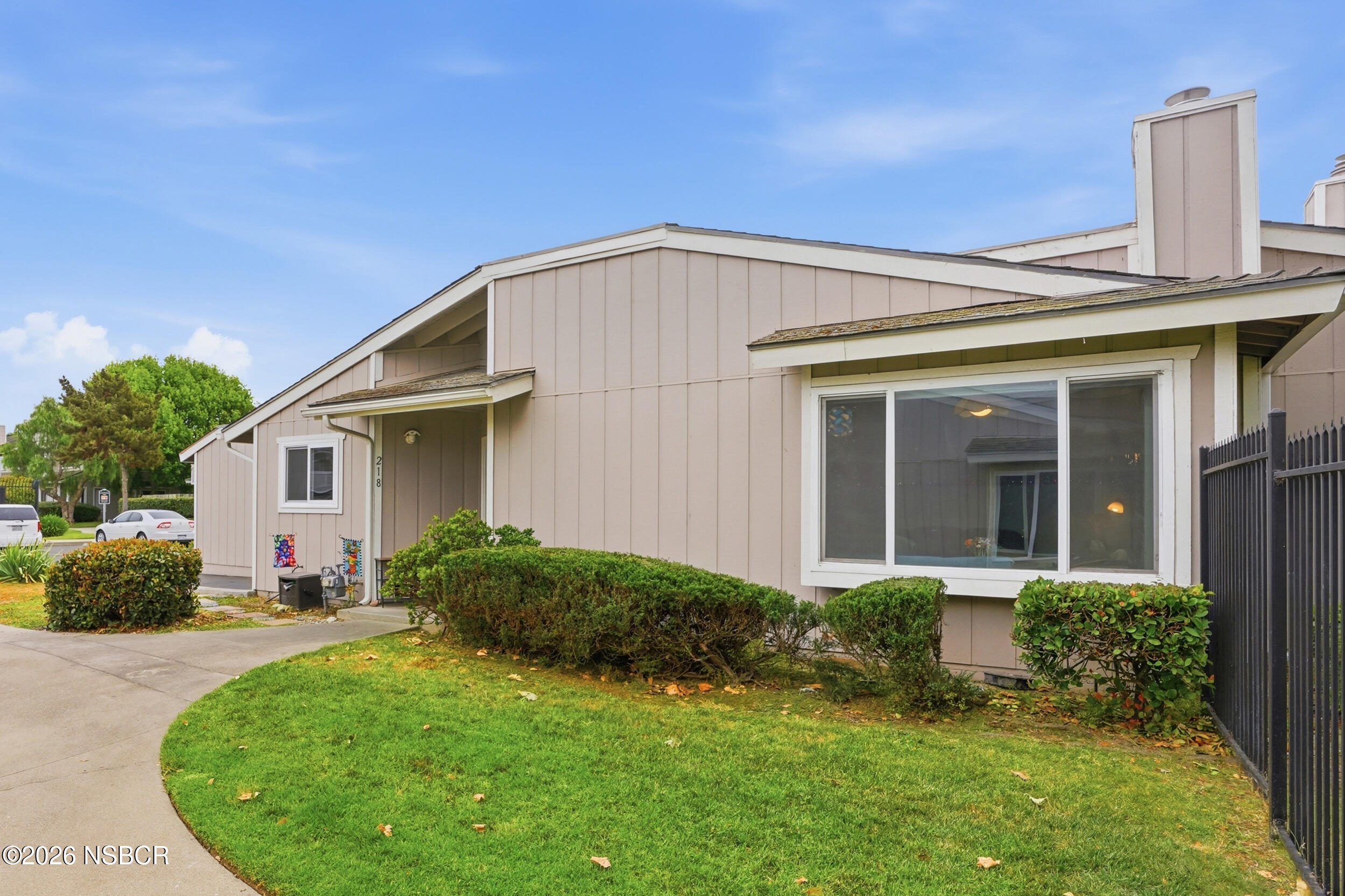 218 North R Street Lompoc, CA 93436 - Photo 3 of 24 a front view of a house with a yard