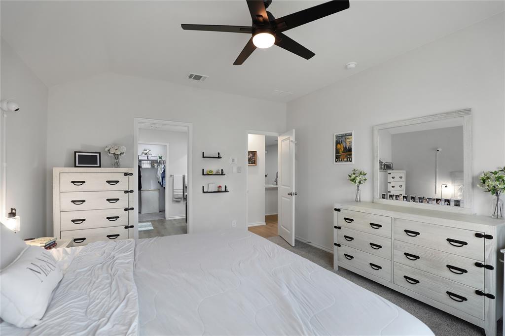 6538 Diver Street Princeton, TX 75407 - Photo 15 of 31 Bedroom with light colored carpet, ceiling fan, connected bathroom, and vaulted ceiling