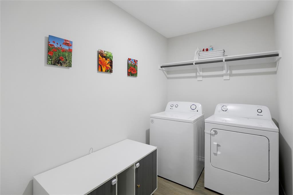 6538 Diver Street Princeton, TX 75407 - Photo 20 of 31 Laundry area featuring light wood finished floors and separate washer and dryer