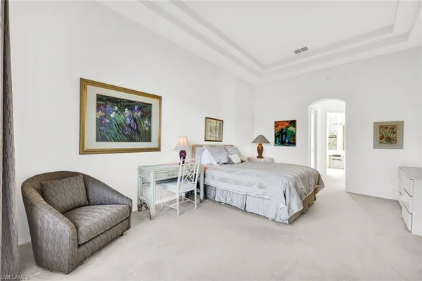 a spacious bedroom with a bed and a couch