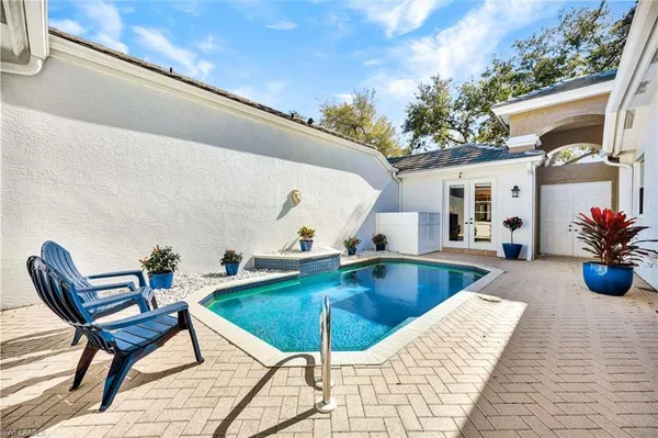 a swimming pool with outdoor seating and yard