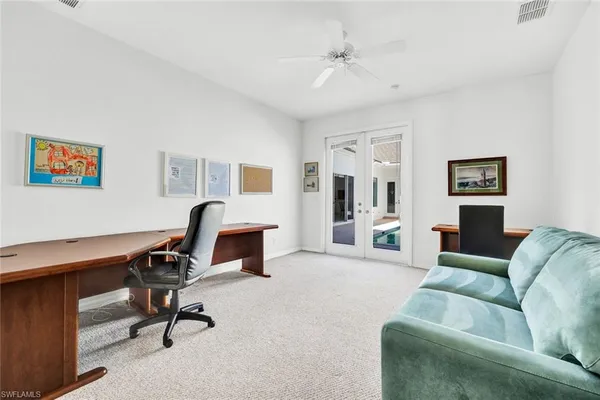 a view of a livingroom with workspace and a couch
