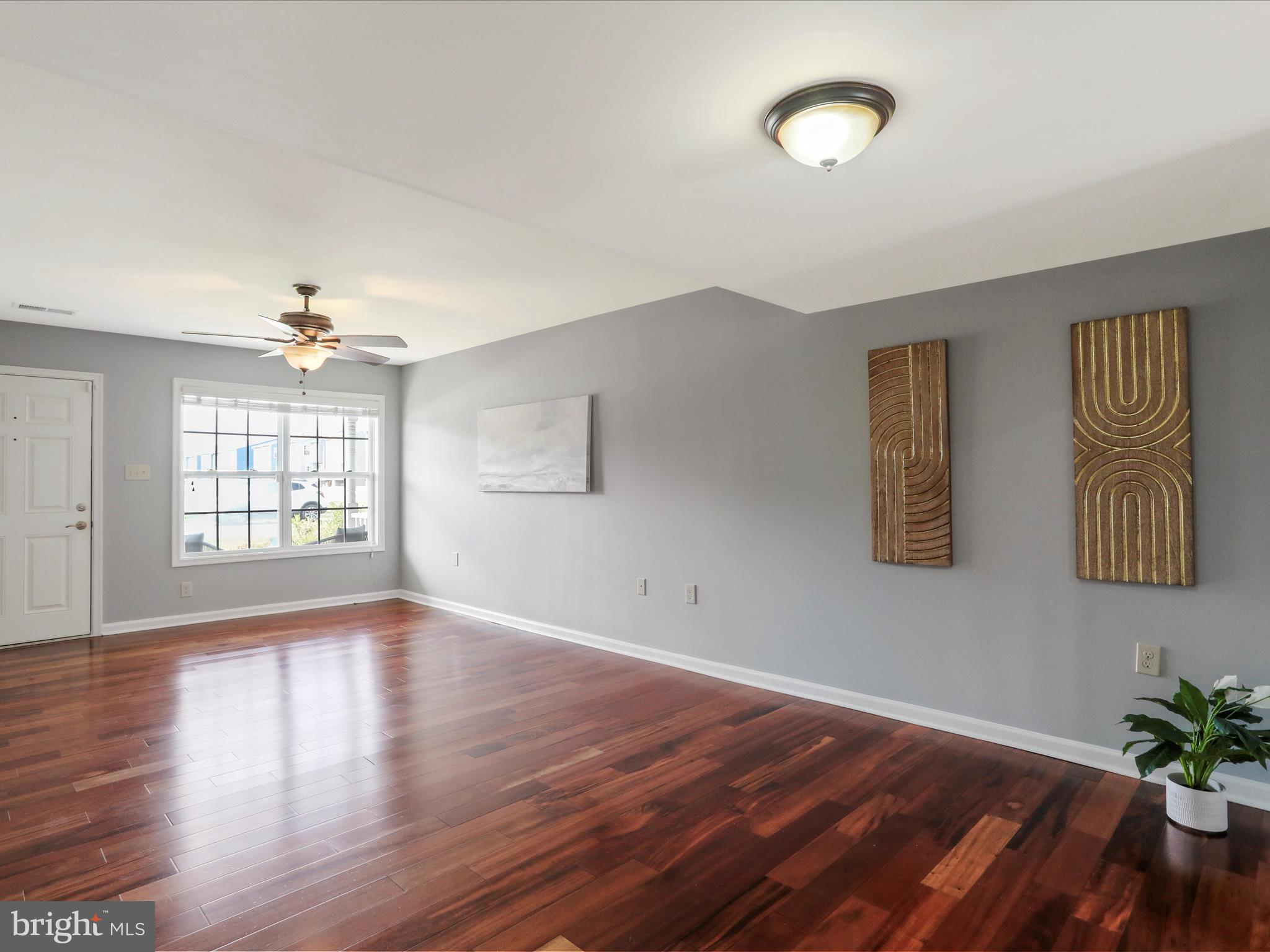 508 Thumper Drive Ranson, WV 25438 - Photo 5 of 45 an empty room with wooden floor and windows