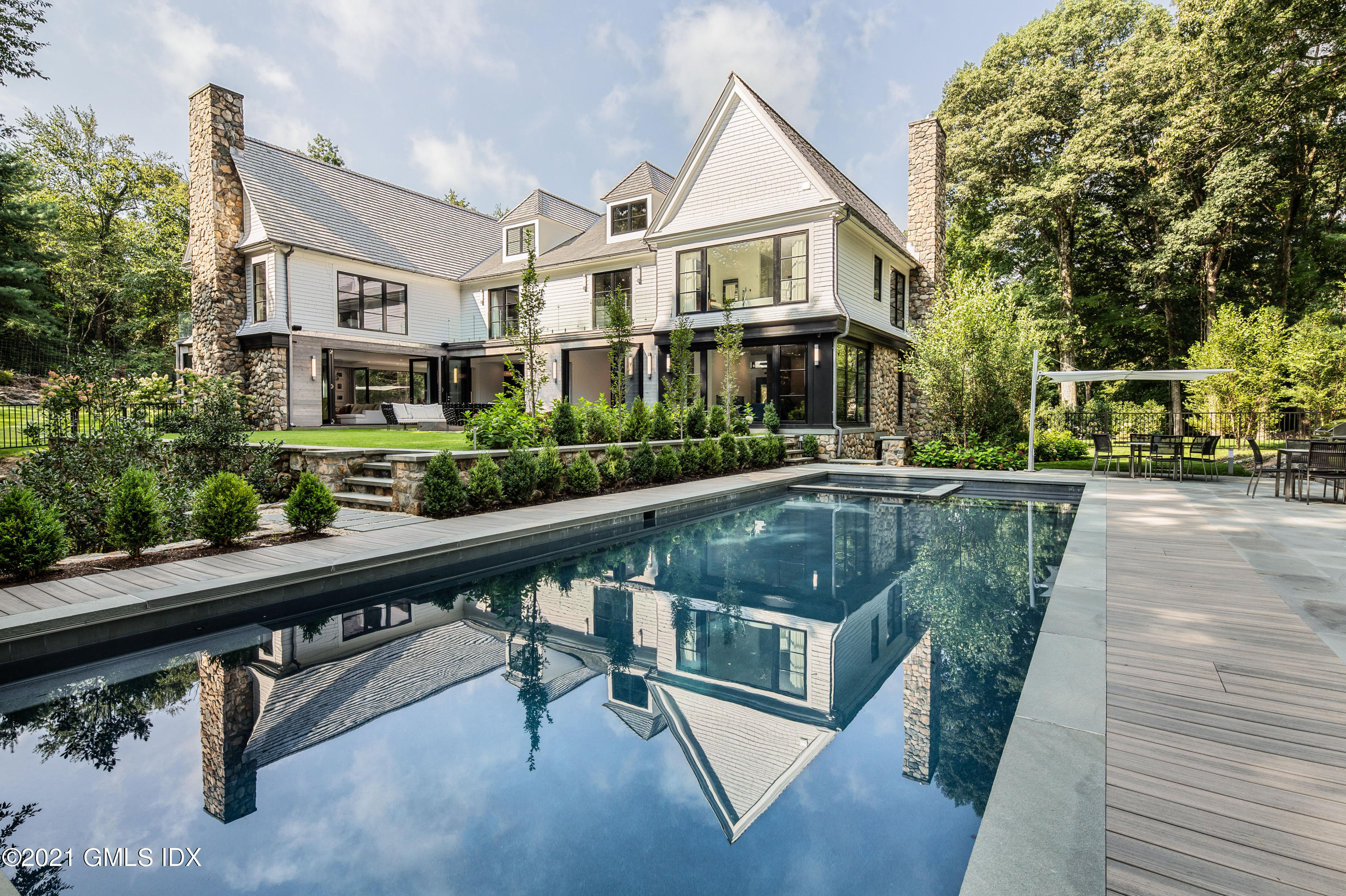 a view of residential houses with cars and trees