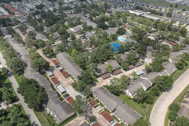 an aerial view of residential houses with outdoor space