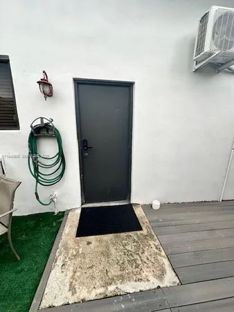 a living room with a rug and a garden