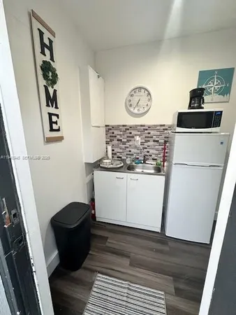 a view of a refrigerator and a stove