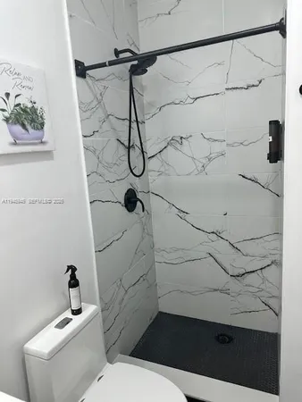 a bathroom with a toilet and shower