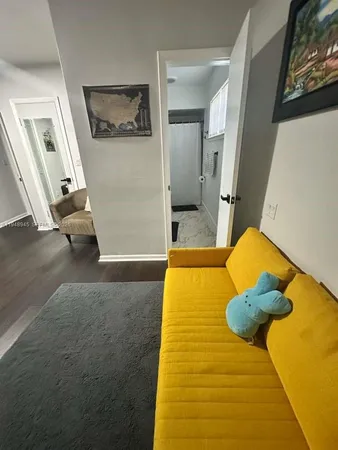 a bedroom with a bed and teddy bear on bed