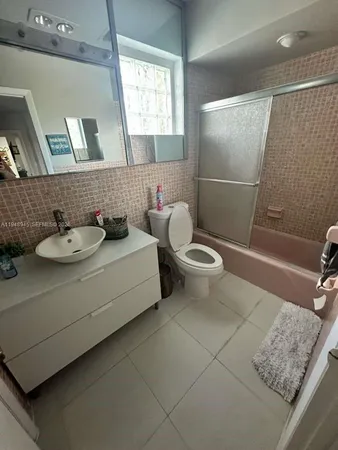 a bathroom with a sink a toilet and mirror