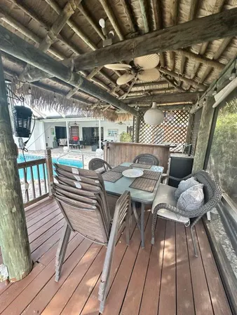 a view of a chairs and table in backyard