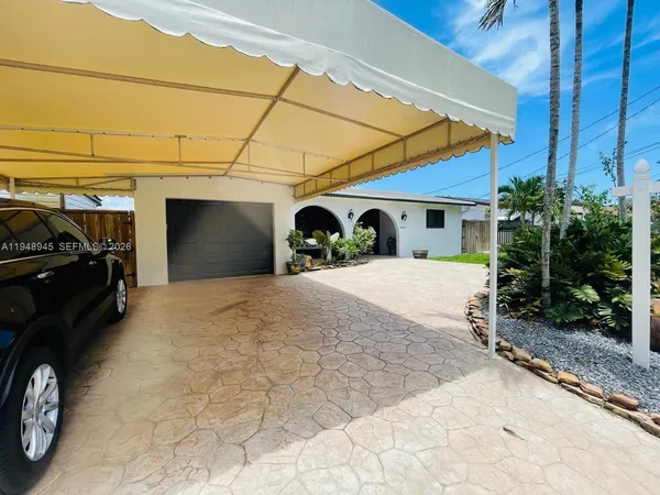 a view of a car in front of garage