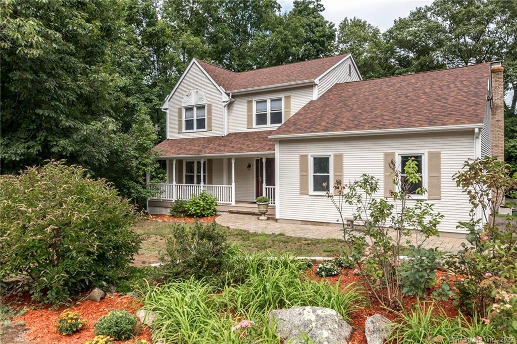 a front view of a house with yard and green space