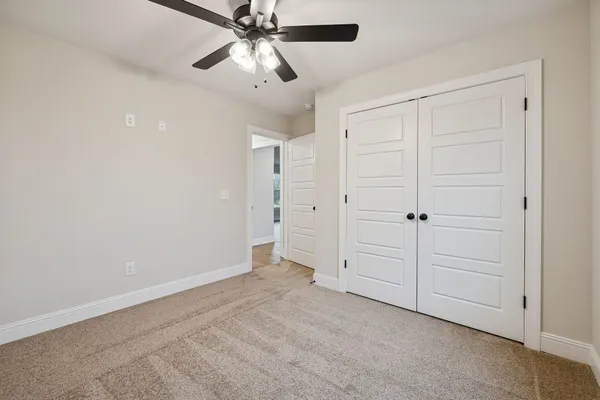 an empty room with a ceiling fan
