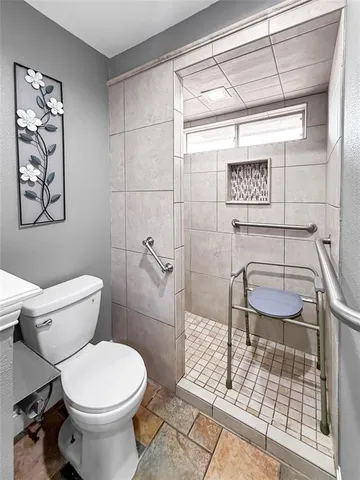 a bathroom with a toilet and a shower