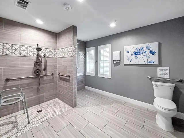 a bathroom with a toilet sink and shower