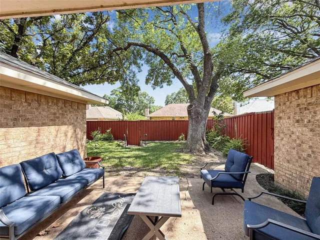 a backyard of a house with outdoor seating