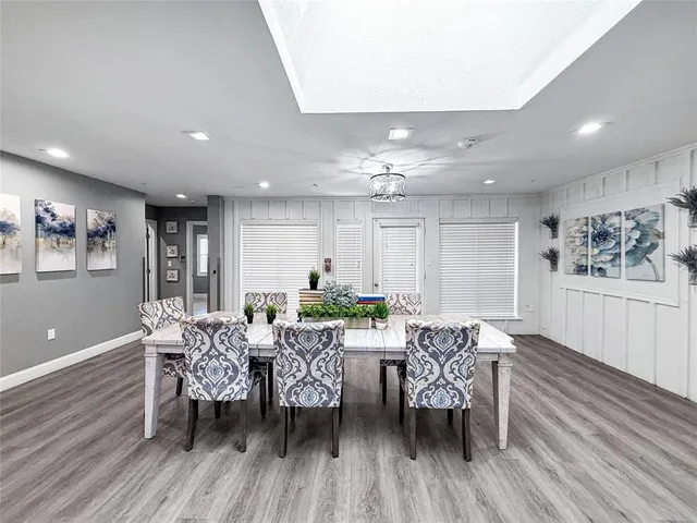 a view of a dining room with furniture and wooden floor