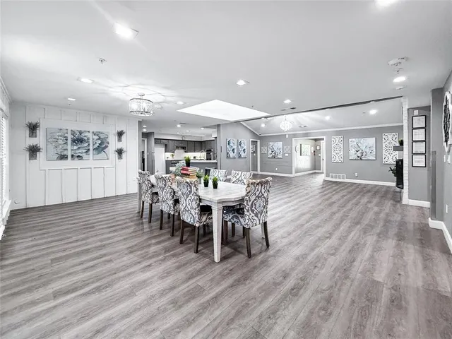 a dining room with furniture and wooden floor