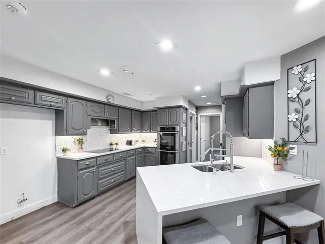 a kitchen with appliances a sink and cabinets