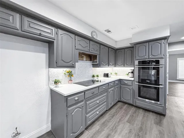 a kitchen with stainless steel appliances granite countertop a sink and cabinets