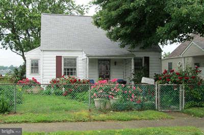 8208 Northview Road Baltimore, MD 21222 - Photo 1 of 5 a front view of a house with a garden and plants