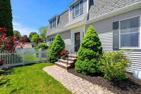 a view of a house with a yard and plants
