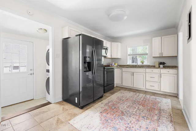a kitchen with stainless steel appliances granite countertop a refrigerator sink and cabinets