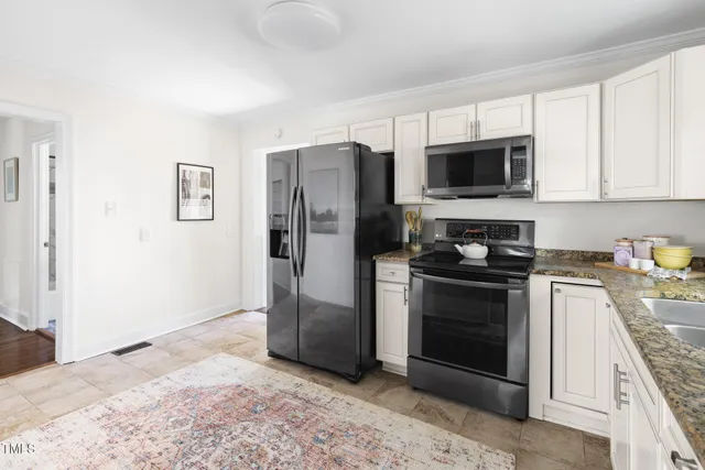 a kitchen with stainless steel appliances granite countertop a refrigerator stove and microwave