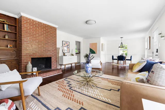 a living room with fireplace furniture and a fireplace