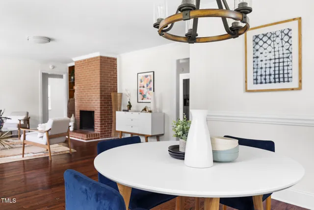 a dining room with table chairs and wooden floor