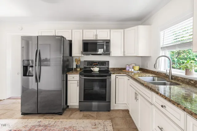 a kitchen with a refrigerator stove and sink