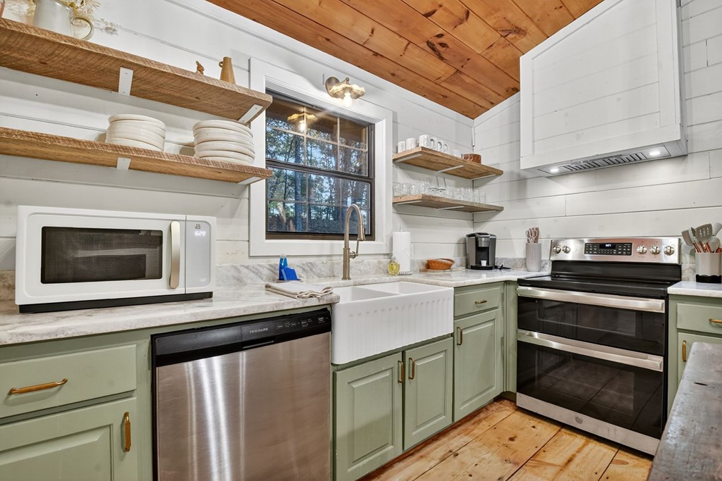50 Lake View Drive Cherry Log, GA 30522 - Photo 9 of 27 a kitchen with stainless steel appliances kitchen island a white stove top oven and cabinets