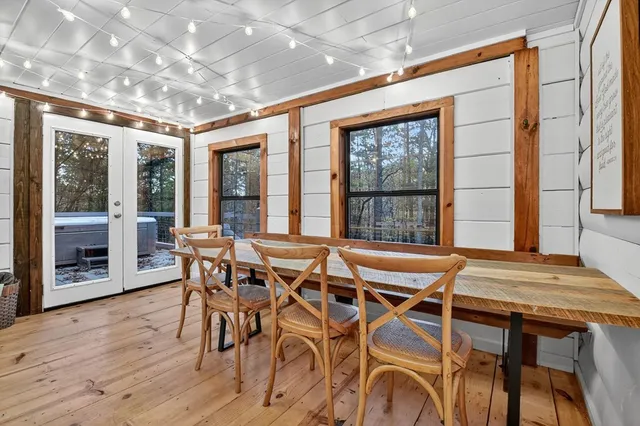 a view of a dining room with furniture wooden floor and chandelier