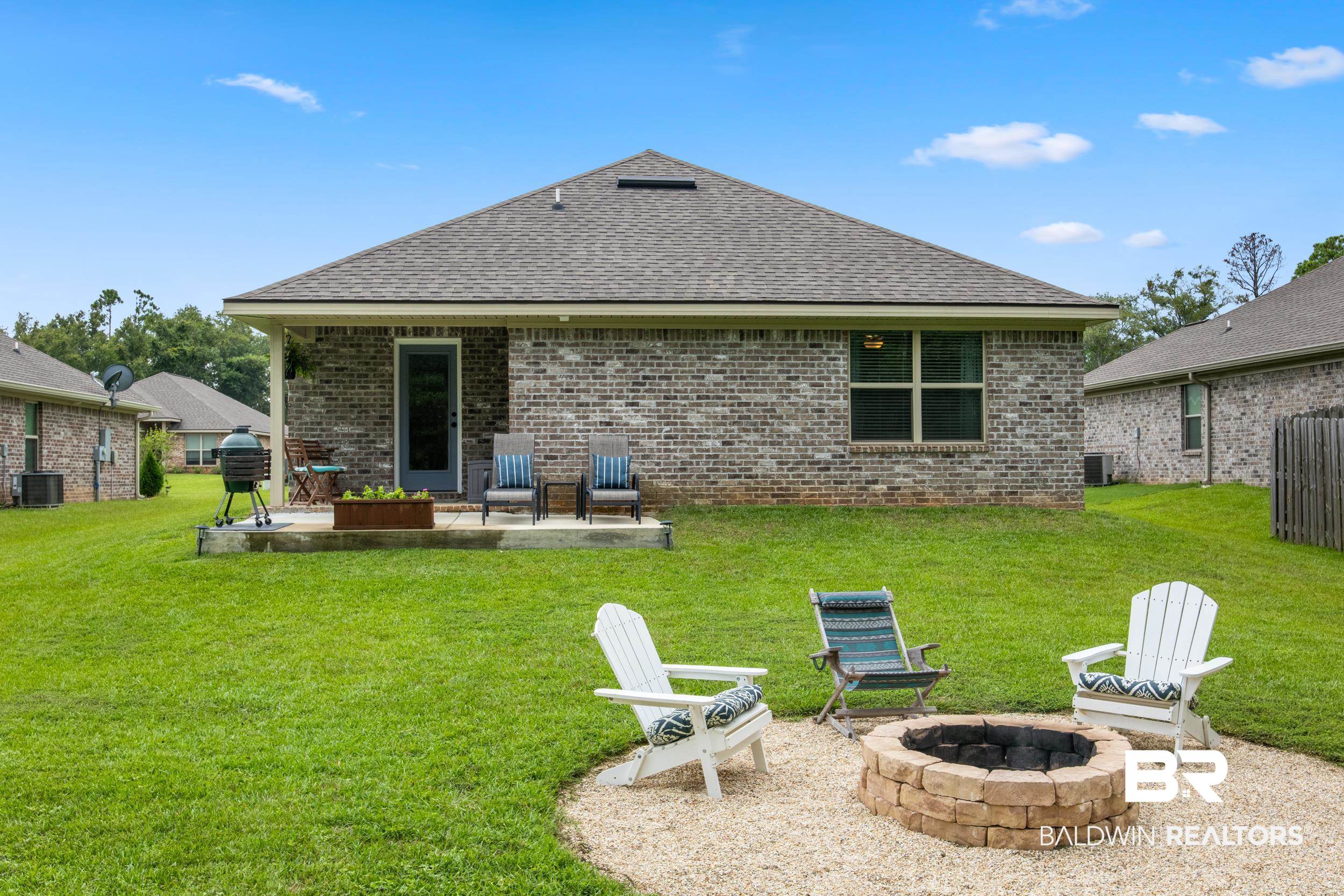 3852 Chesterfield Lane Foley, AL 36535 - Photo 7 of 34 Rear view of property with an outdoor fire pit, a patio area, a lawn, and central AC unit