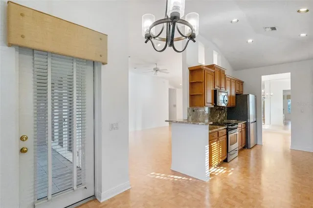 a kitchen with stainless steel appliances granite countertop a refrigerator a oven a sink and dishwasher