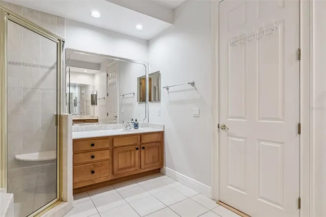 a bathroom with a double vanity sink a mirror and a bathtub