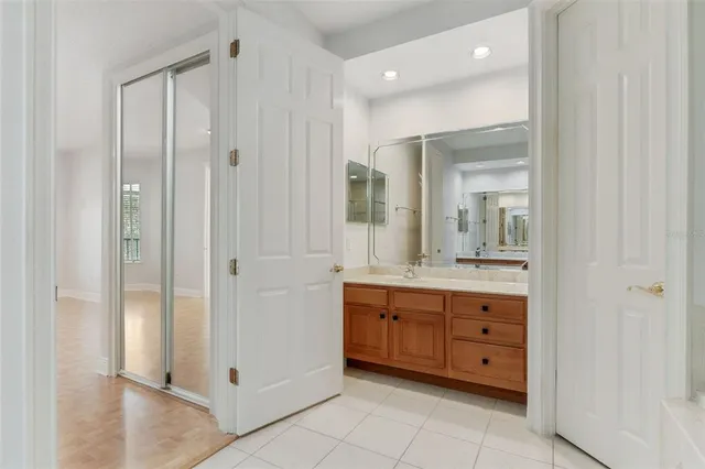 a bathroom with a granite countertop sink mirror and bathtub