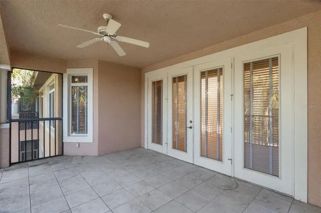 a view of a livingroom with a ceiling fan and window