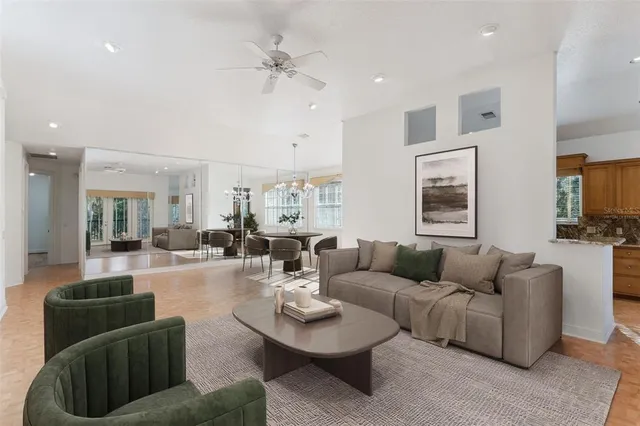 a living room with furniture and a view of kitchen